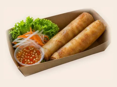 Twee gefrituurde loempia’s in een bakje, met salade en zoetzure dipsaus